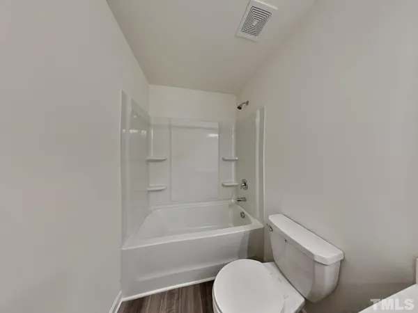 a bathroom with a toilet and a bathtub