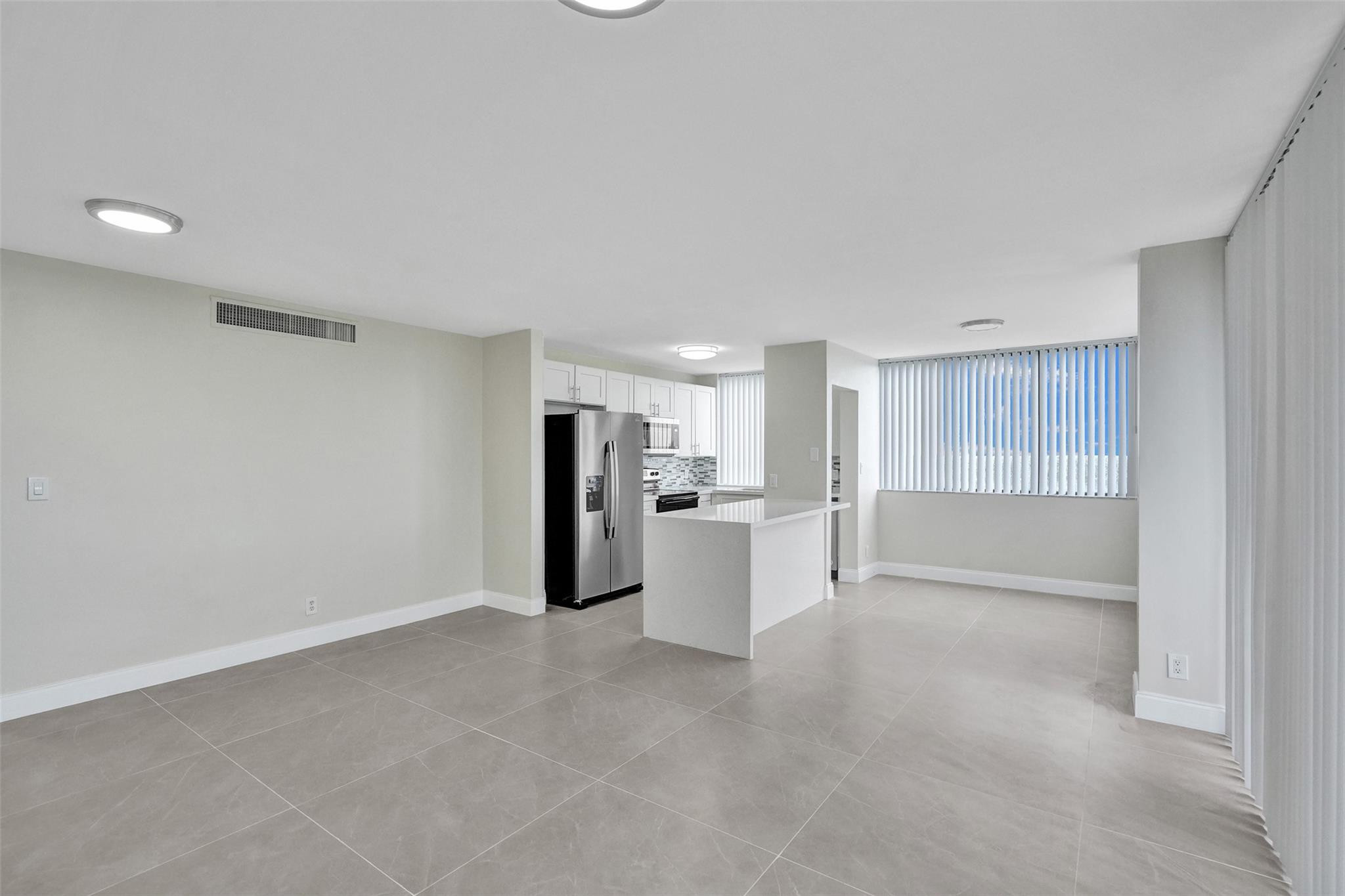 4222 Inverrary Boulevard, Unit 4810 Lauderhill, FL 33319 - Photo 8 of 63 a view of a kitchen with refrigerator and microwave