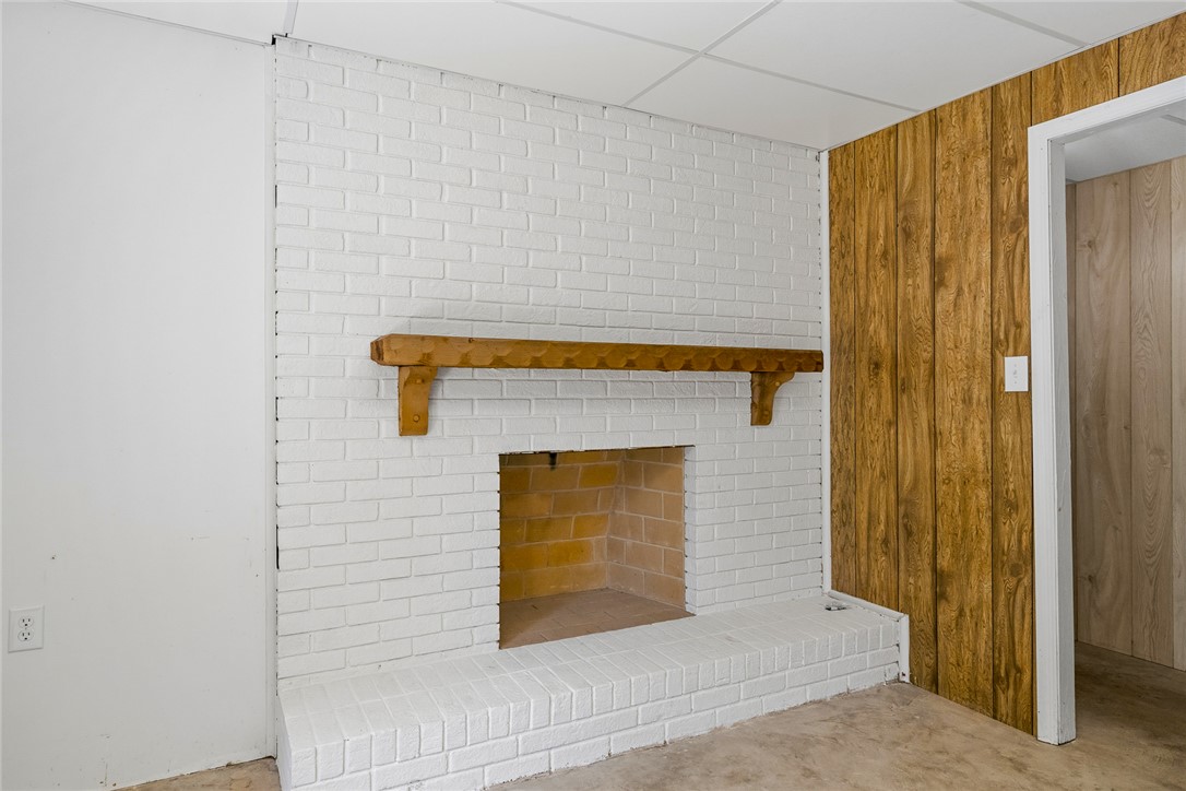 208 Williamsburg Road Anderson, SC 29621 - Photo 35 of 48 A classic brick fireplace features a rustic wood mantel in this versatile basement space.