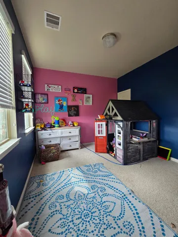 a bedroom with furniture and a dresser