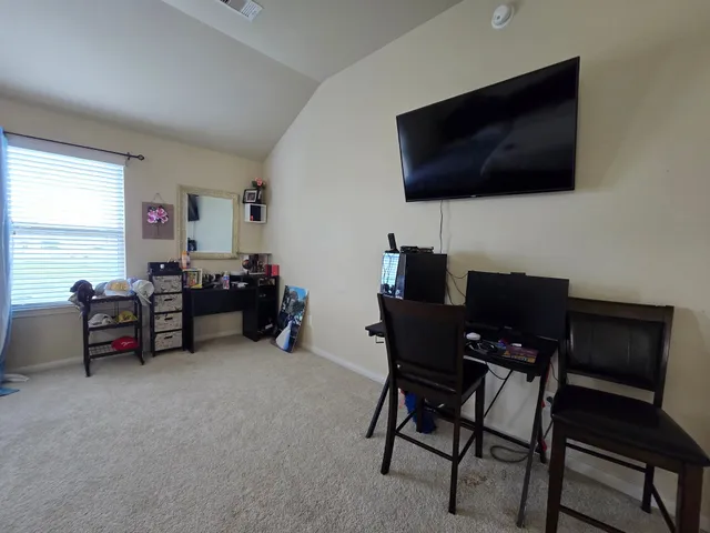 a view of a livingroom with furniture and a flat screen tv
