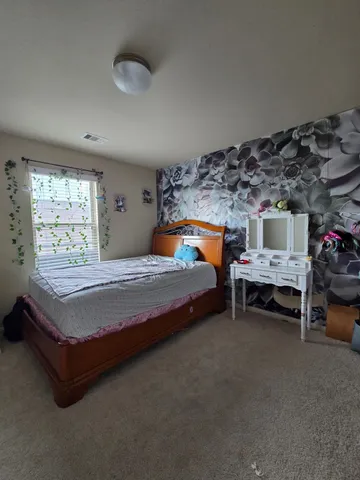 a bedroom with a bed and a table in it