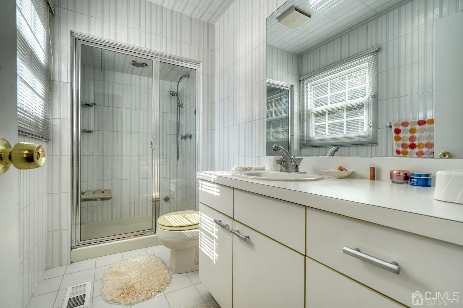 19 Morningside Drive Old Bridge, NJ 08857 - Photo 15 of 40 a bathroom with a granite countertop sink a toilet a shower and a mirror