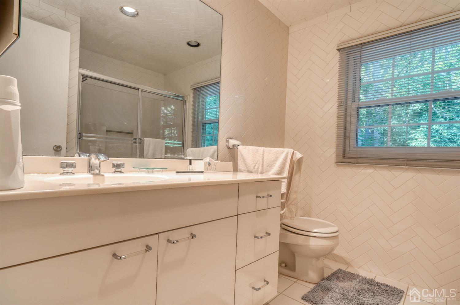 19 Morningside Drive Old Bridge, NJ 08857 - Photo 26 of 40 a bathroom with a toilet sink and mirror