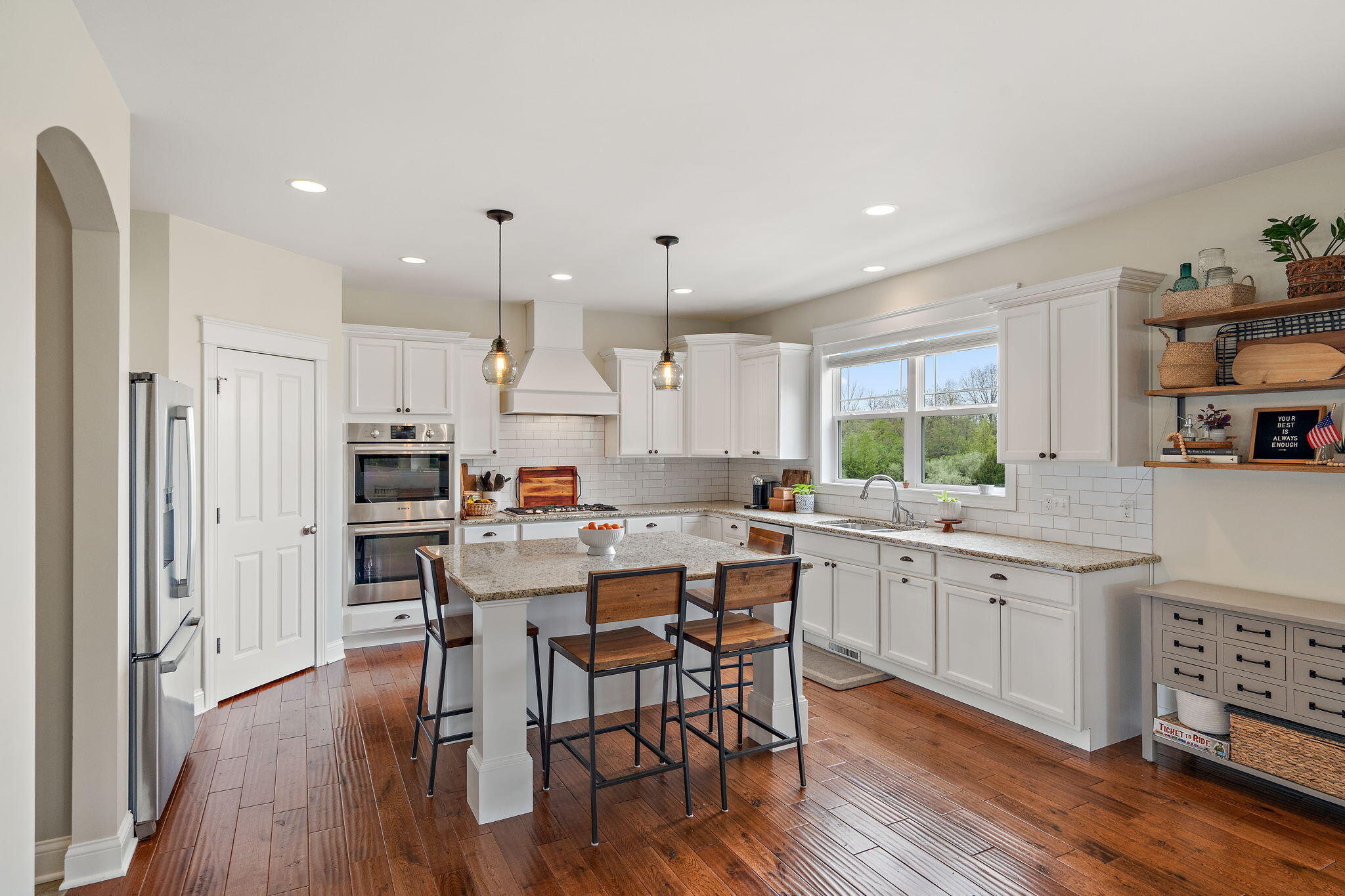 1684 Kleven Lane Crown Point, IN 46307 - Photo 11 of 55 a kitchen with stainless steel appliances a dining table chairs stove refrigerator and cabinets
