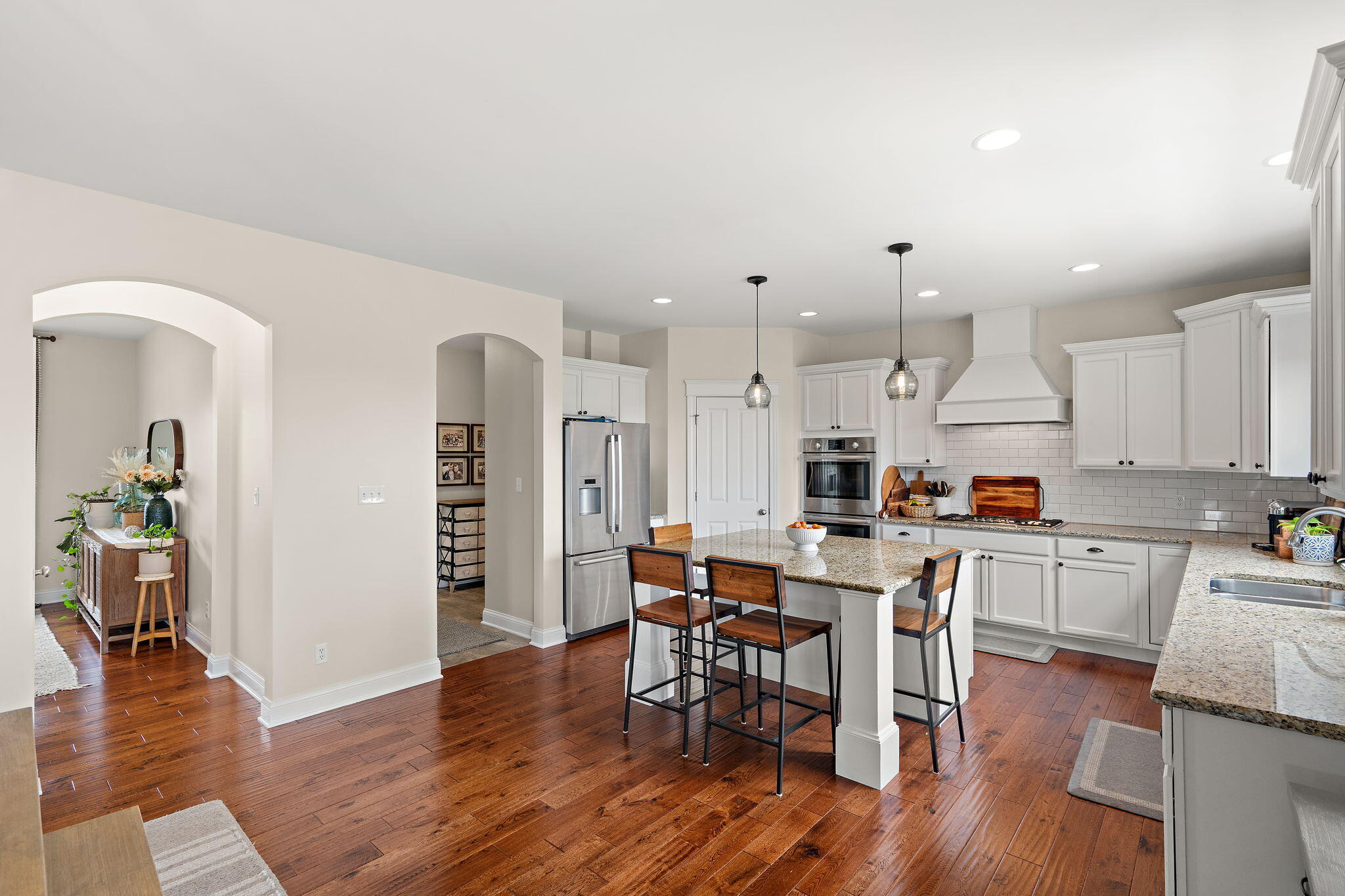 1684 Kleven Lane Crown Point, IN 46307 - Photo 16 of 55 a kitchen with stainless steel appliances a dining table chairs stove and cabinets