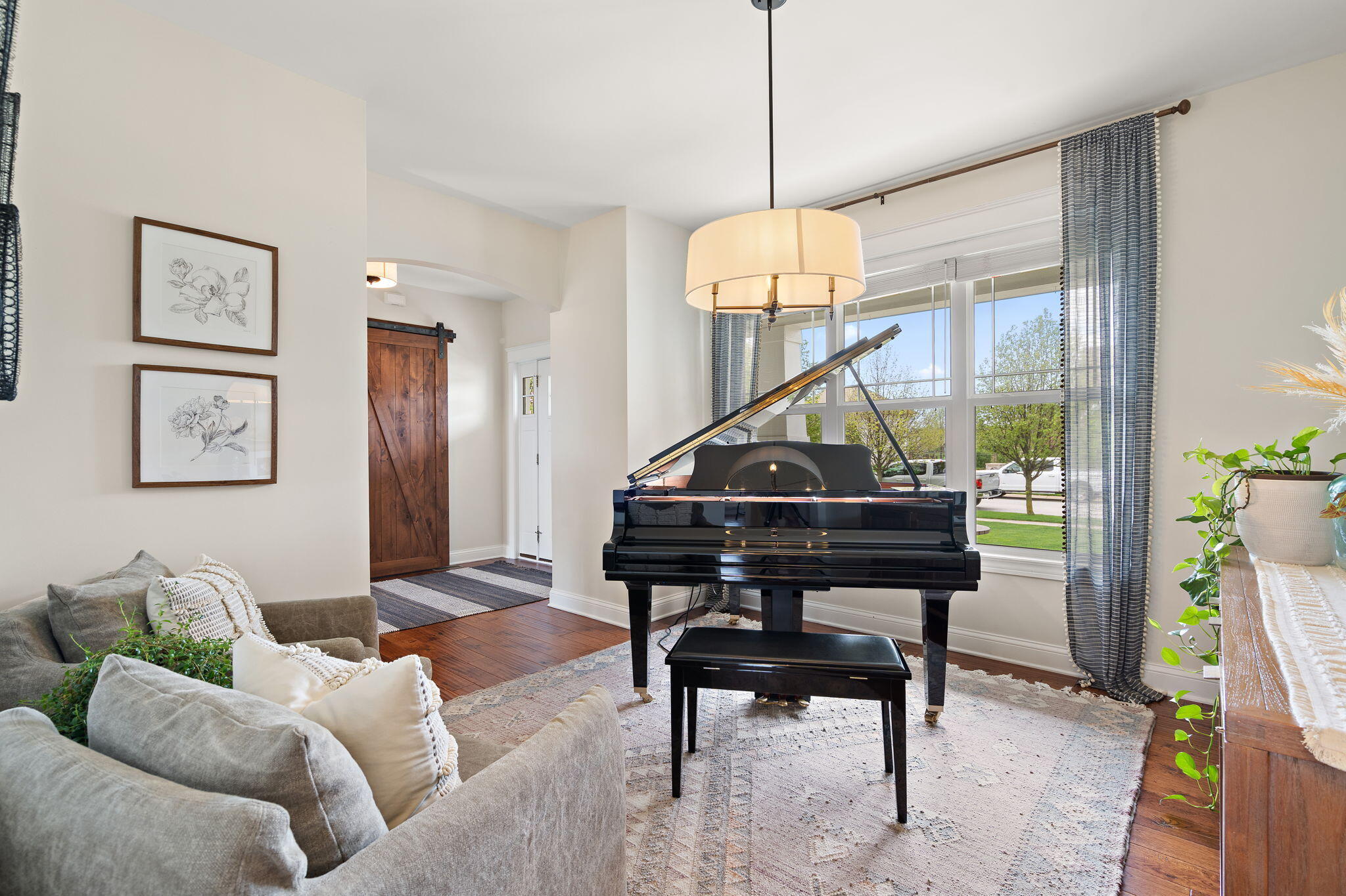 1684 Kleven Lane Crown Point, IN 46307 - Photo 5 of 55 a living room with furniture a piano and a chandelier