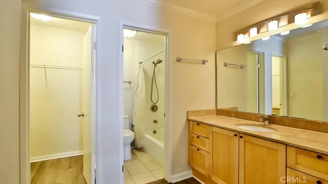 a spacious bathroom with a granite countertop sink mirror and a shower