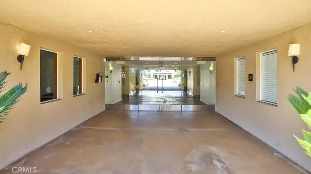 a view of a hallway with furniture and windows