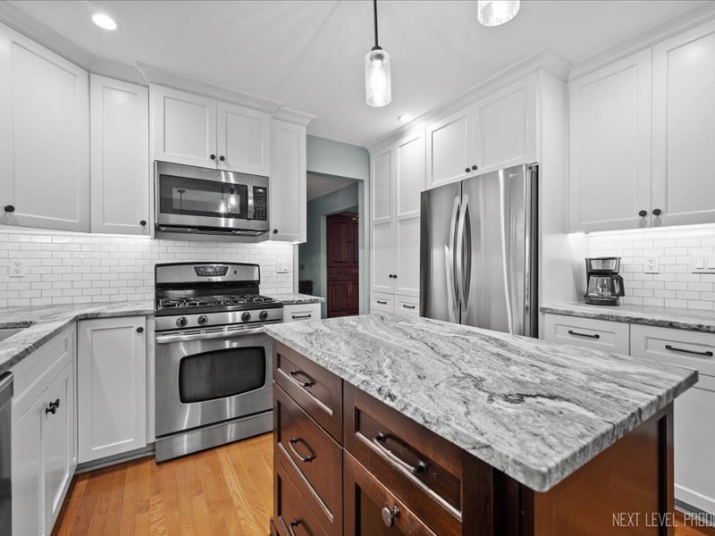 2040 Forest Ridge Road St. Charles, IL 60174 - Photo 12 of 33 a kitchen with granite countertop a center island stainless steel appliances and cabinets