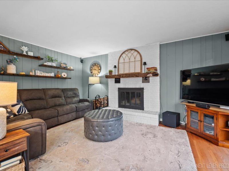 2040 Forest Ridge Road St. Charles, IL 60174 - Photo 15 of 33 a living room with furniture a flat screen tv and a fireplace