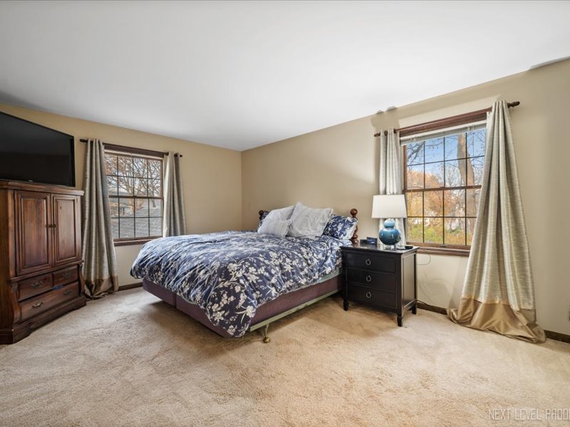 2040 Forest Ridge Road St. Charles, IL 60174 - Photo 18 of 33 a bedroom with a bed and a flat tv screen