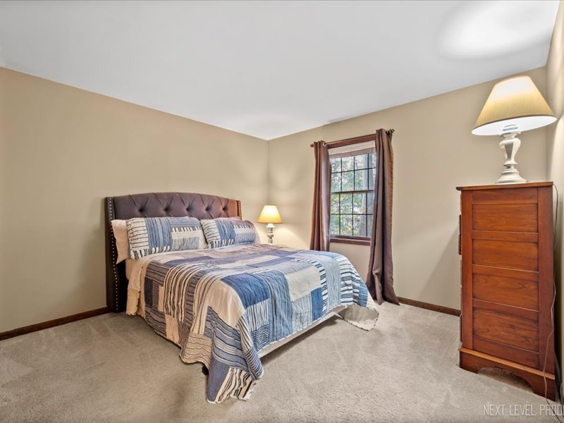 2040 Forest Ridge Road St. Charles, IL 60174 - Photo 25 of 33 a bedroom with a bed and a lamp