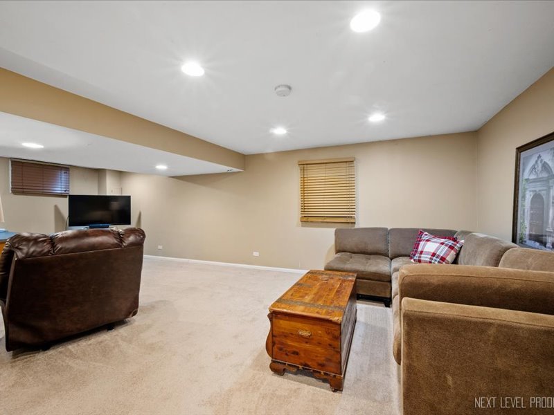 2040 Forest Ridge Road St. Charles, IL 60174 - Photo 27 of 33 a living room with furniture and a flat screen tv