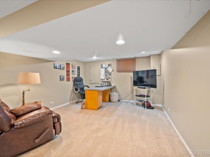 2040 Forest Ridge Road St. Charles, IL 60174 - Photo 28 of 33 a bedroom with a bed a couch and a flat screen tv