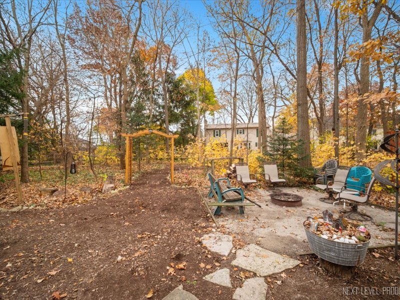 2040 Forest Ridge Road St. Charles, IL 60174 - Photo 31 of 33 a view of a backyard with chairs and a fire pit