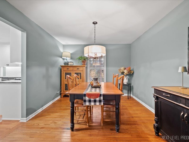 2040 Forest Ridge Road St. Charles, IL 60174 - Photo 9 of 33 a dining room with furniture a chandelier and wooden floor