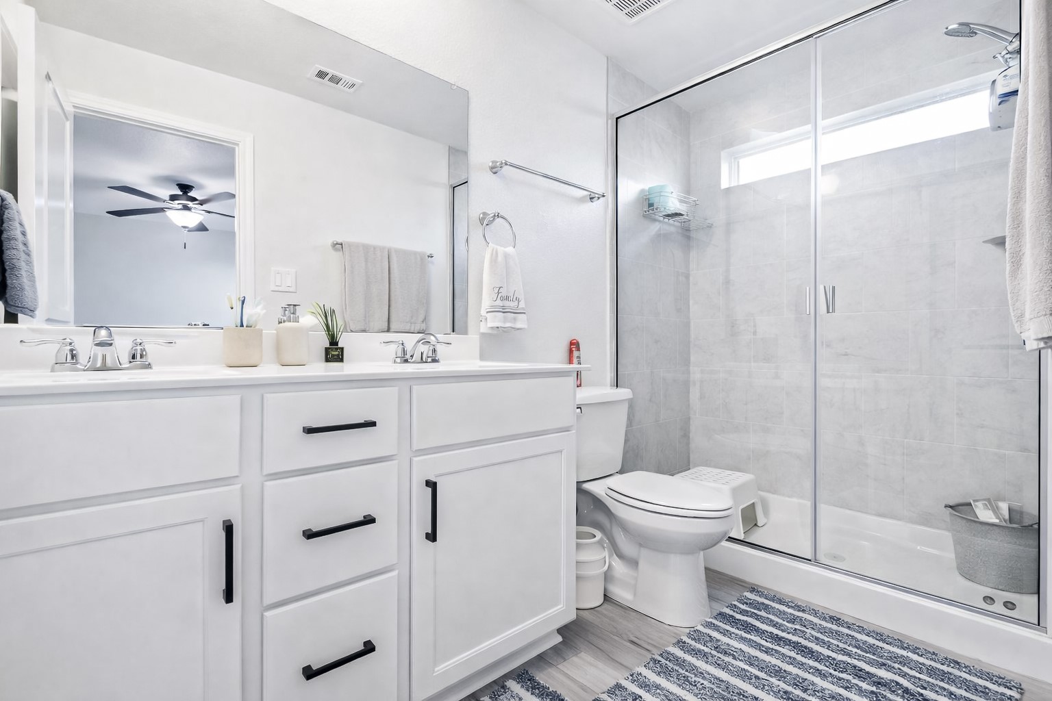 940 Paddock Lane Georgetown, TX 78626 - Photo 24 of 32 Dual vanity with white cabinetry and black hardware