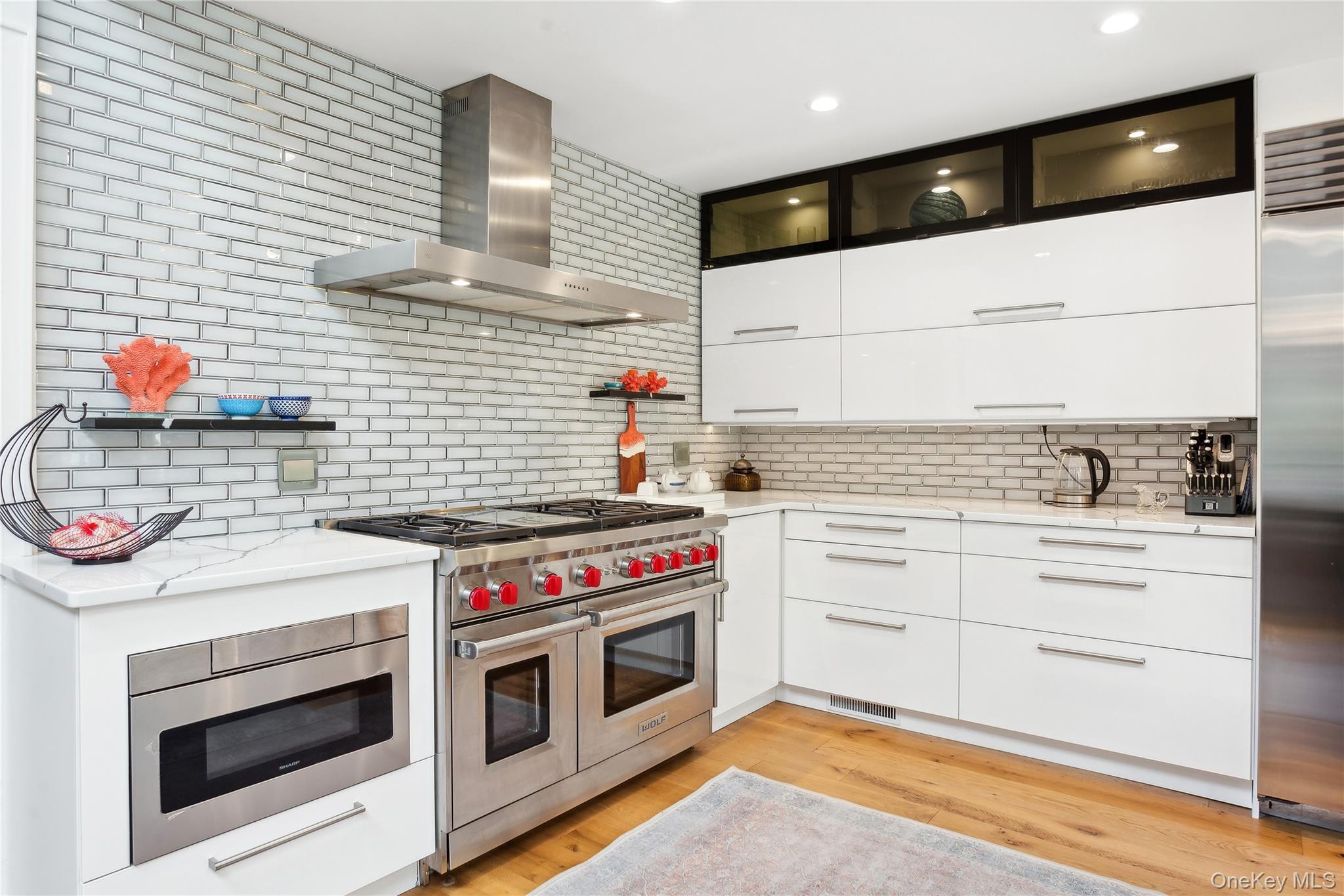 425 Cedar Point Drive East Southold, NY 11971 - Photo 14 of 47 a kitchen with a stove and white cabinets