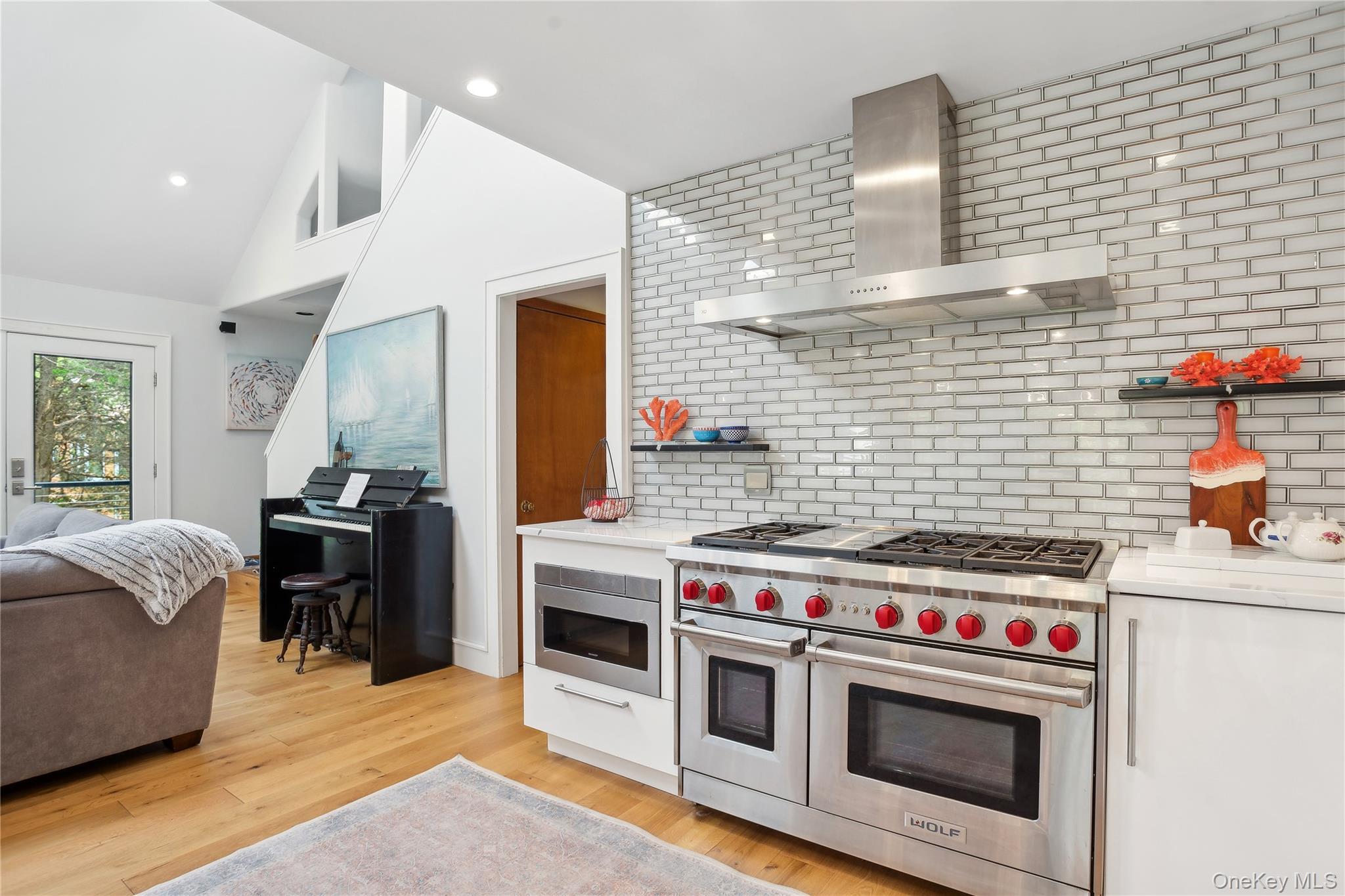 425 Cedar Point Drive East Southold, NY 11971 - Photo 15 of 47 a kitchen with a stove and a wooden floor