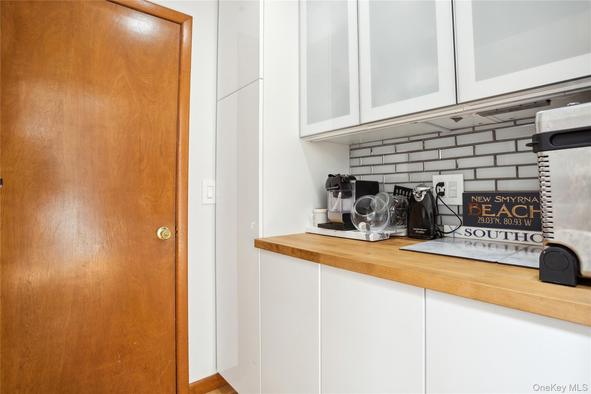 425 Cedar Point Drive East Southold, NY 11971 - Photo 20 of 47 a kitchen with a refrigerator and cabinets