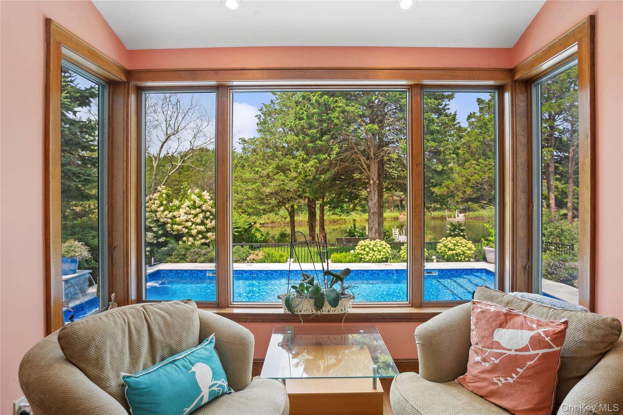 425 Cedar Point Drive East Southold, NY 11971 - Photo 22 of 47 a living room with a large window and a couches