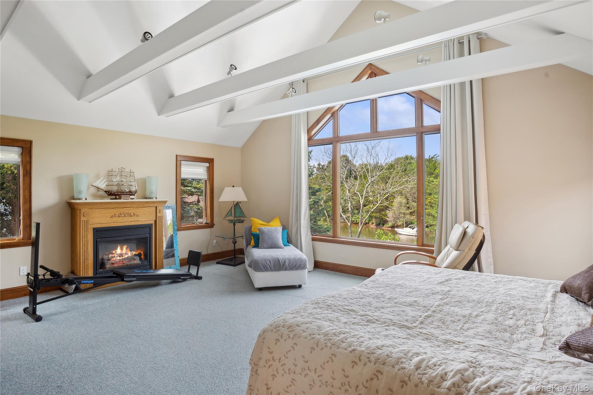 425 Cedar Point Drive East Southold, NY 11971 - Photo 27 of 47 a bedroom with a bed couch and a fireplace