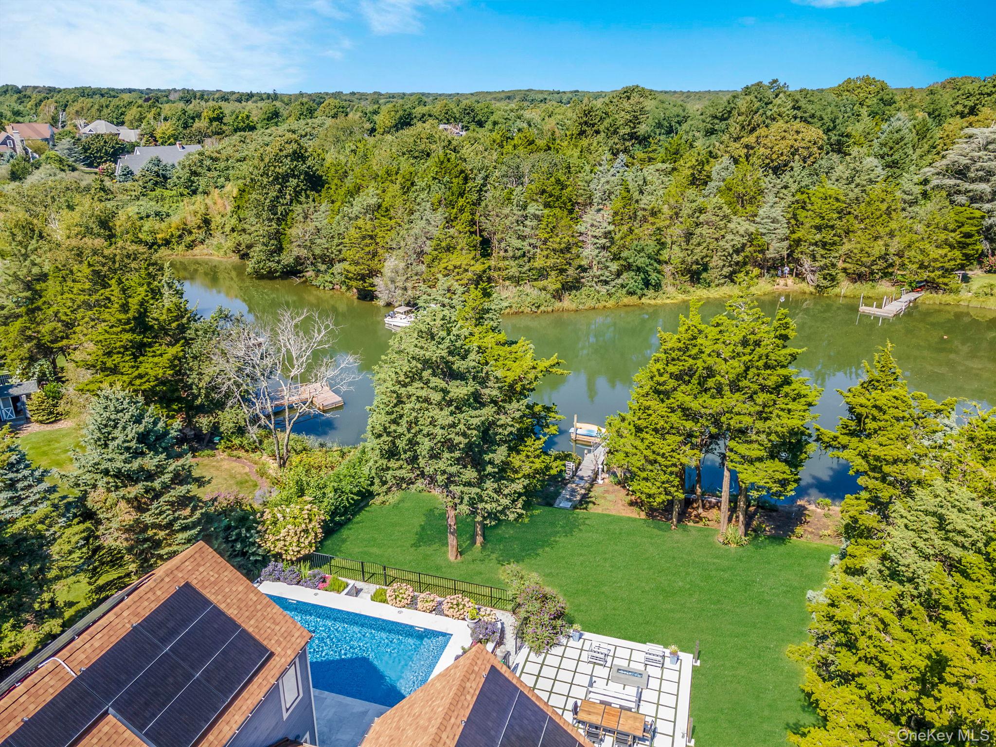 425 Cedar Point Drive East Southold, NY 11971 - Photo 29 of 47 a view of a garden with plants and a lake view