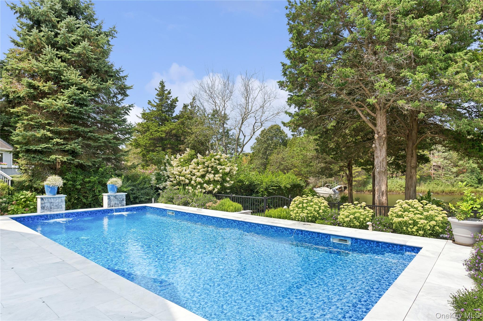 425 Cedar Point Drive East Southold, NY 11971 - Photo 31 of 47 a view of a swimming pool with an outdoor space