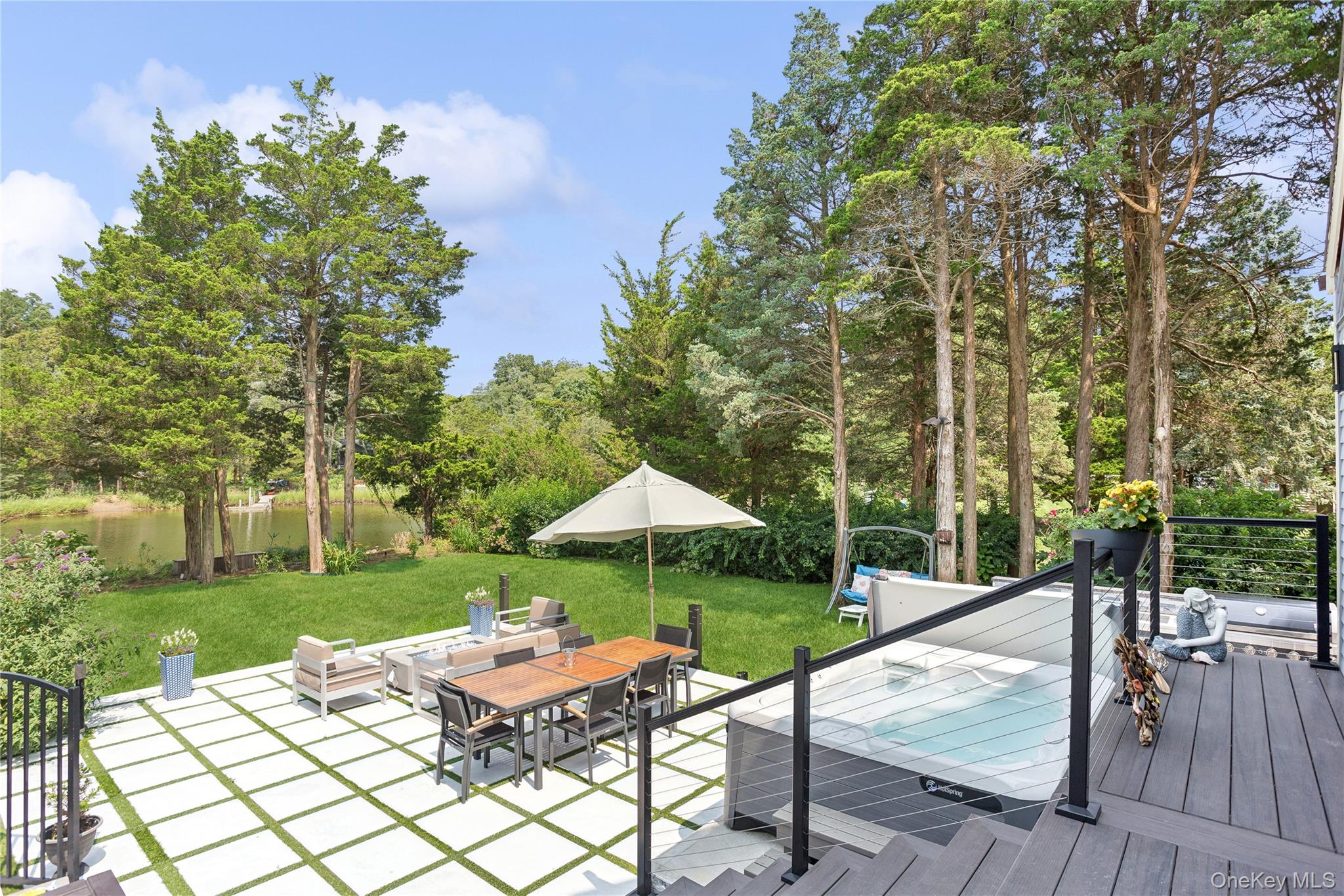 425 Cedar Point Drive East Southold, NY 11971 - Photo 36 of 47 a view of a table and chairs under an umbrella