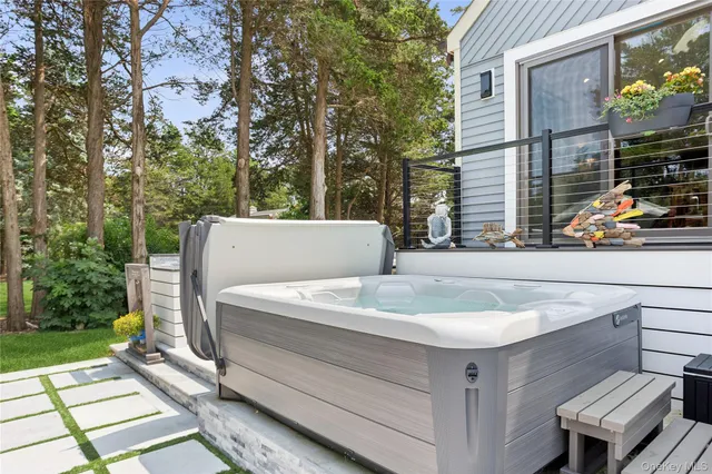 a view of a patio with couches table and chairs and potted plants