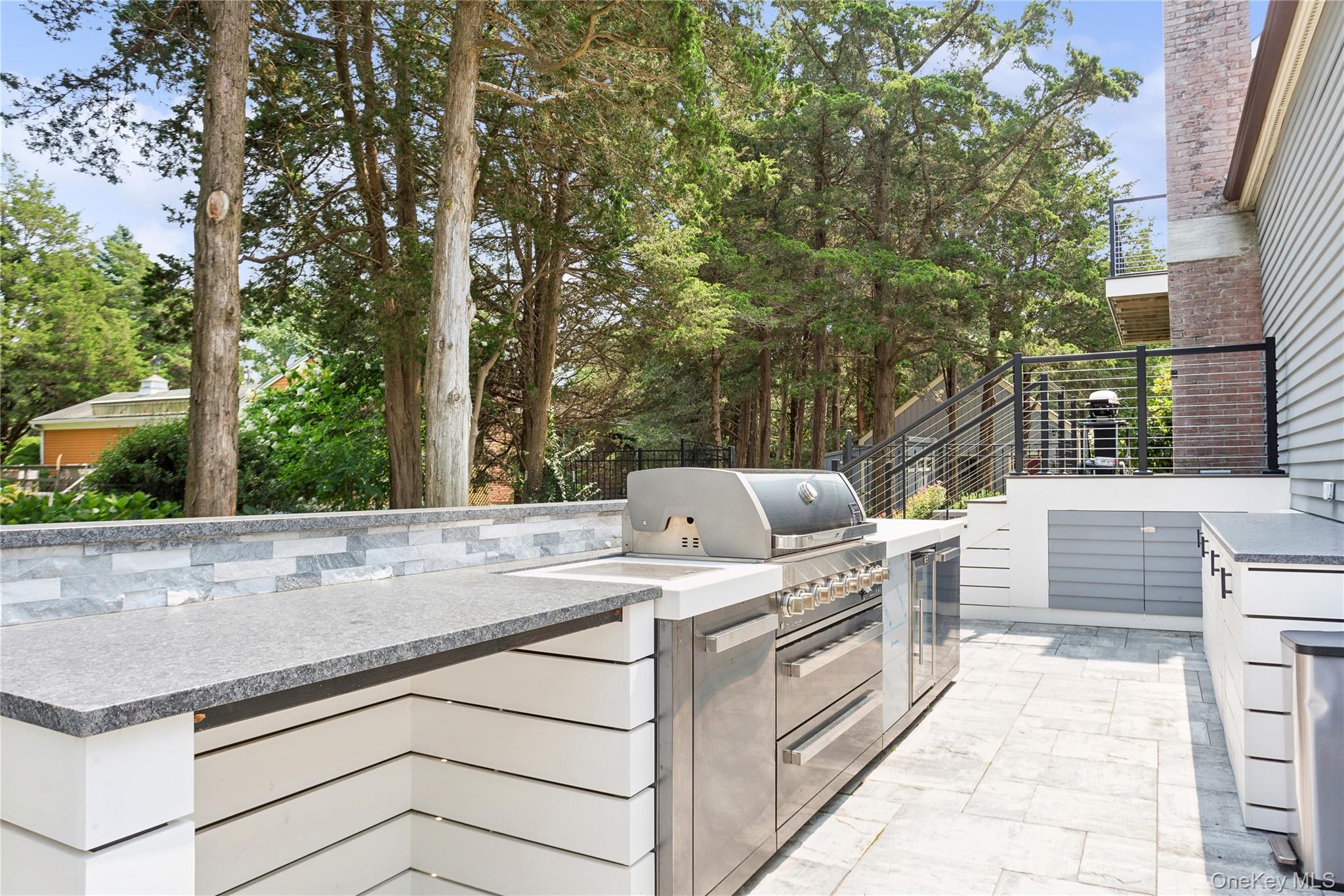 425 Cedar Point Drive East Southold, NY 11971 - Photo 38 of 47 a view of a kitchen with a stove and a large tree