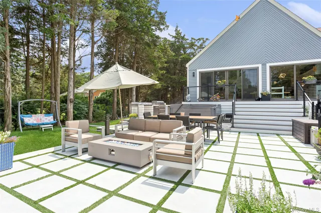 a view of a chair and table in backyard of the house