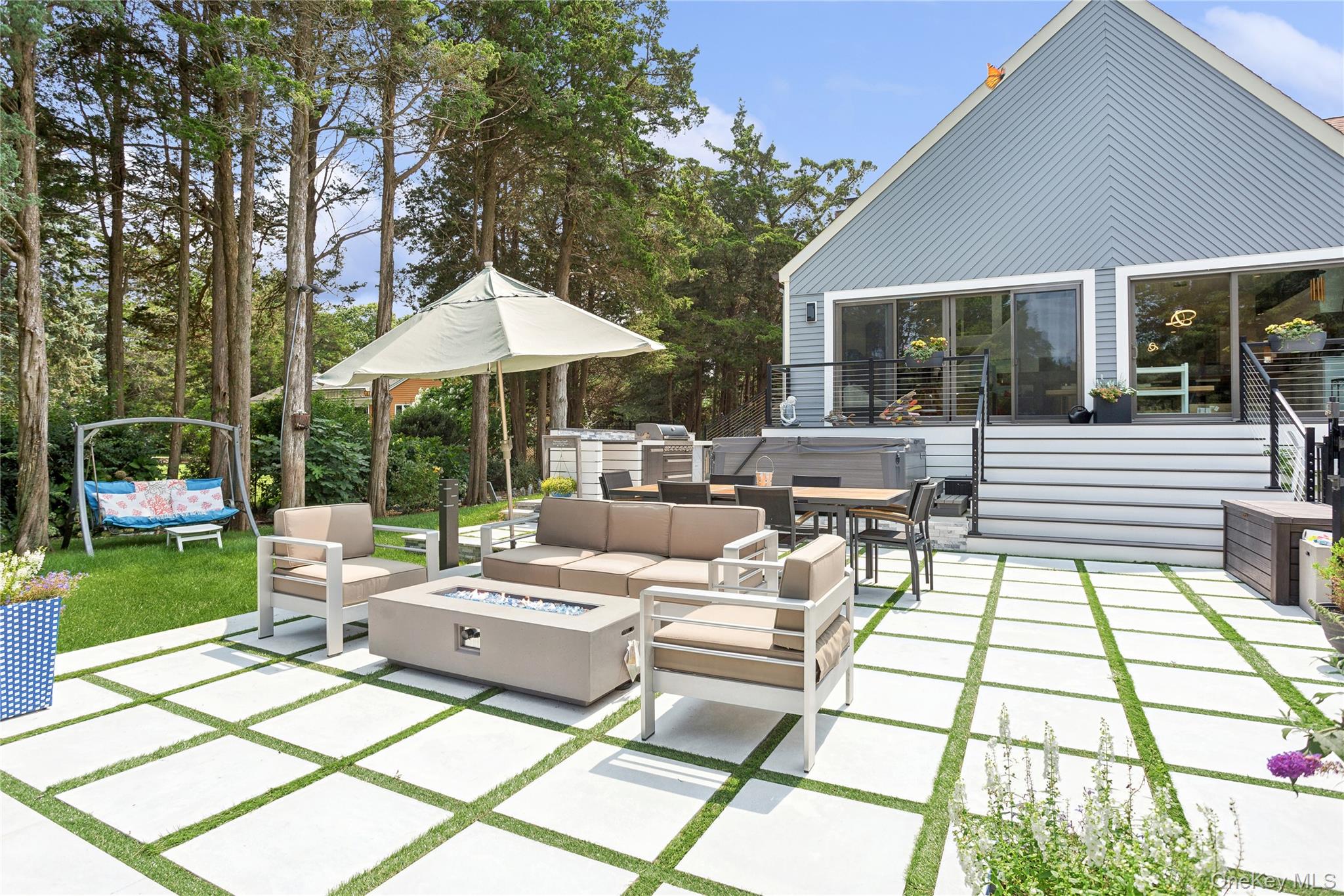 425 Cedar Point Drive East Southold, NY 11971 - Photo 39 of 47 a view of a patio with couches table and chairs and potted plants