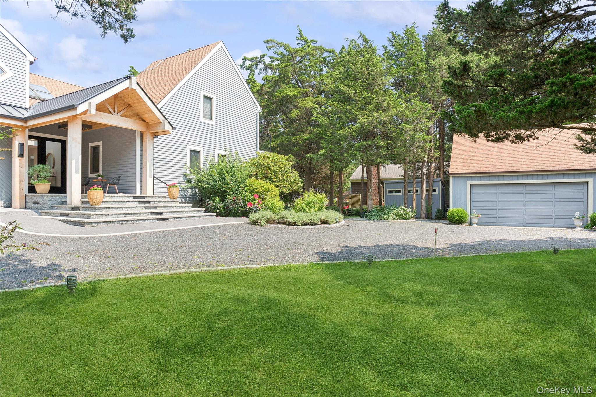 425 Cedar Point Drive East Southold, NY 11971 - Photo 4 of 47 a front view of a house with a yard and trees