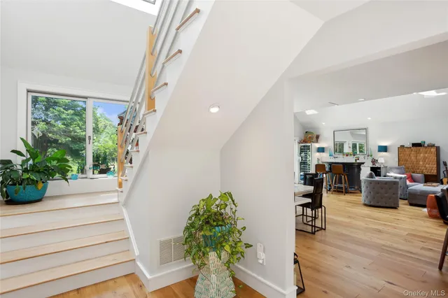 a dining room with stainless steel appliances kitchen island granite countertop a table and chairs