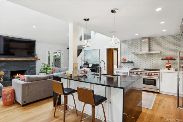 a kitchen with stainless steel appliances kitchen island granite countertop a table and chairs in it