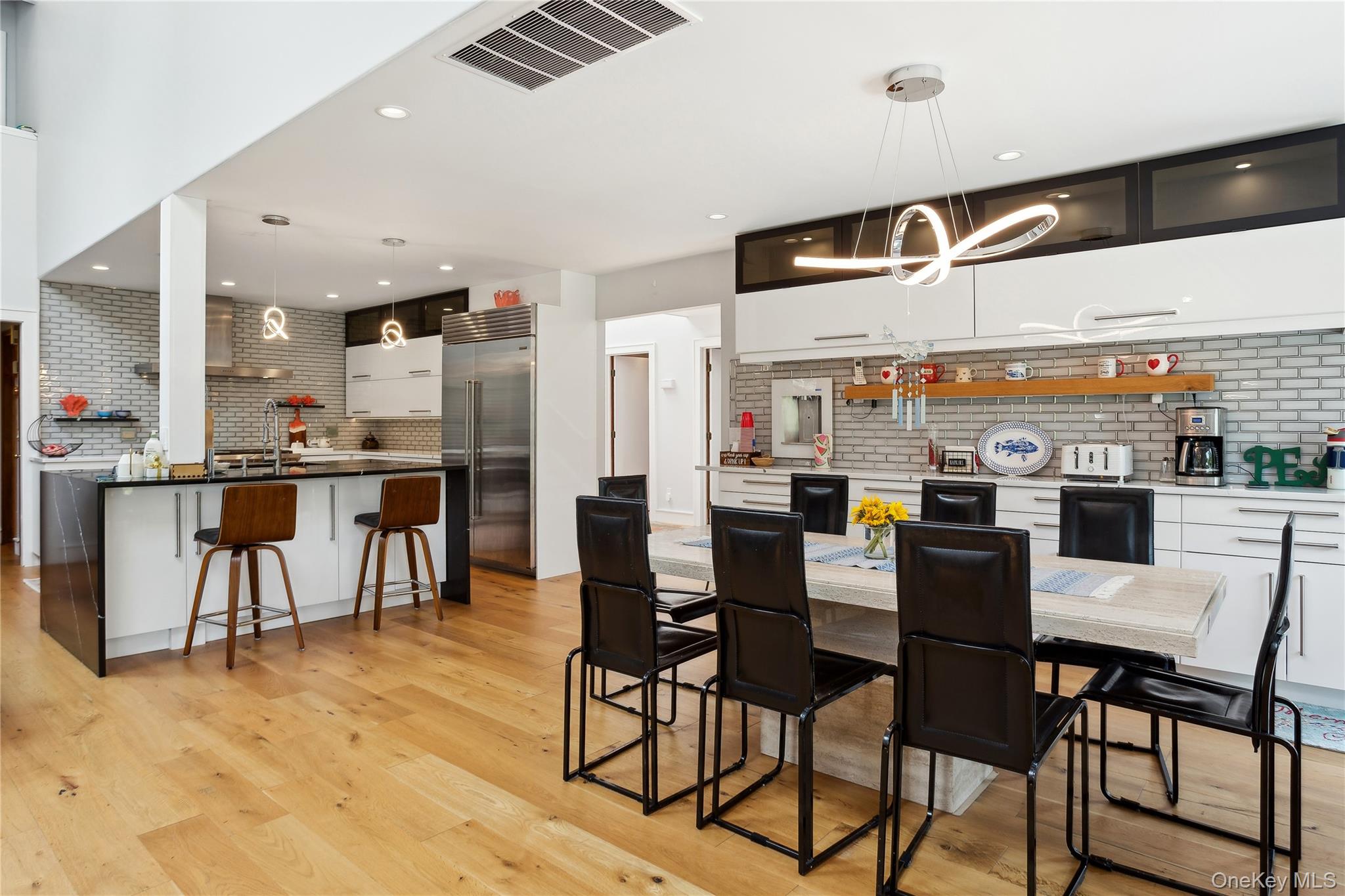 425 Cedar Point Drive East Southold, NY 11971 - Photo 10 of 47 a dining room with stainless steel appliances kitchen island granite countertop a table and chairs
