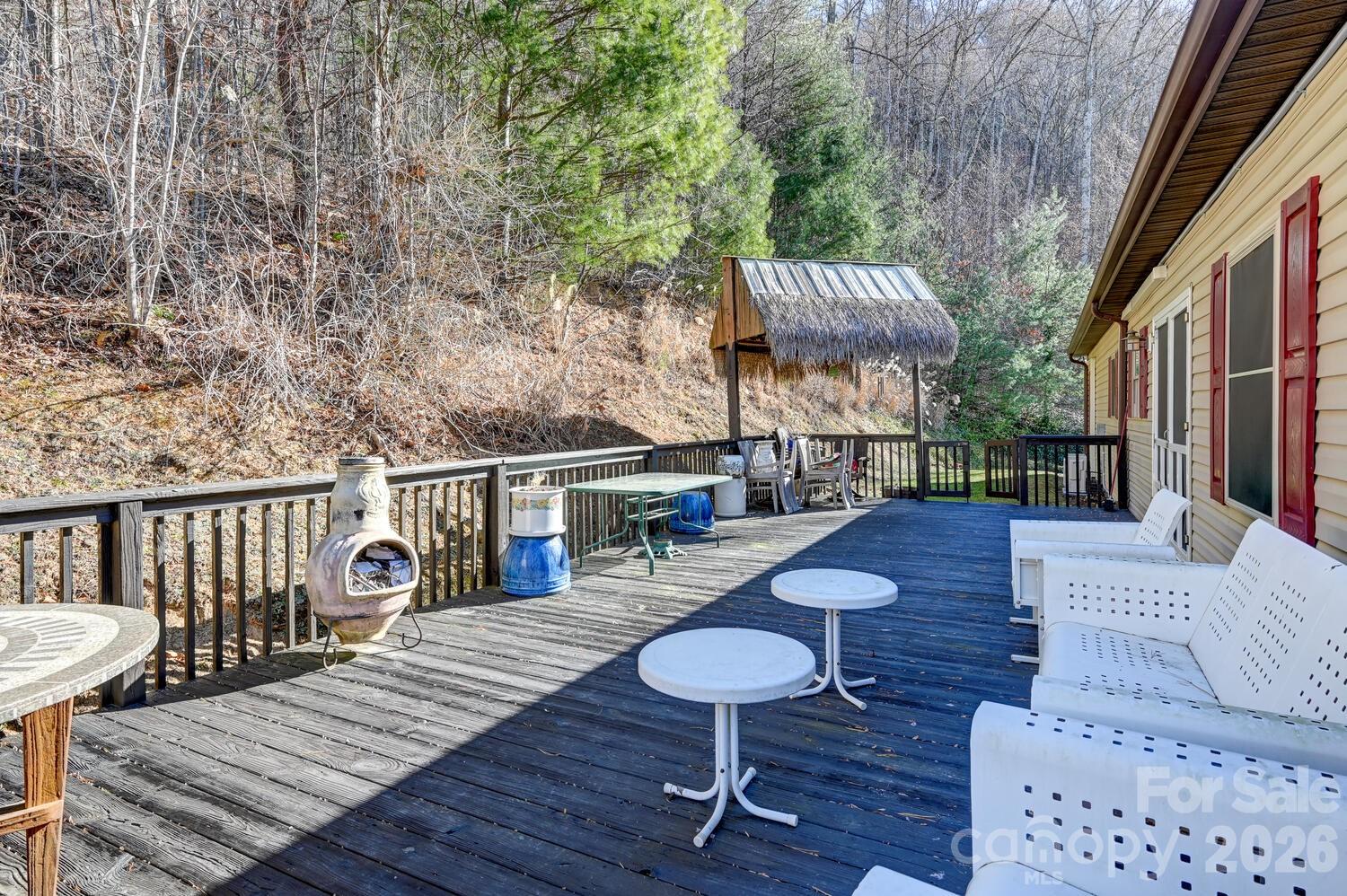 2 Ruffed Grouse Drive Weaverville, NC 28787 - Photo 33 of 44 a view of a deck with couches table and chairs with wooden floor and fence