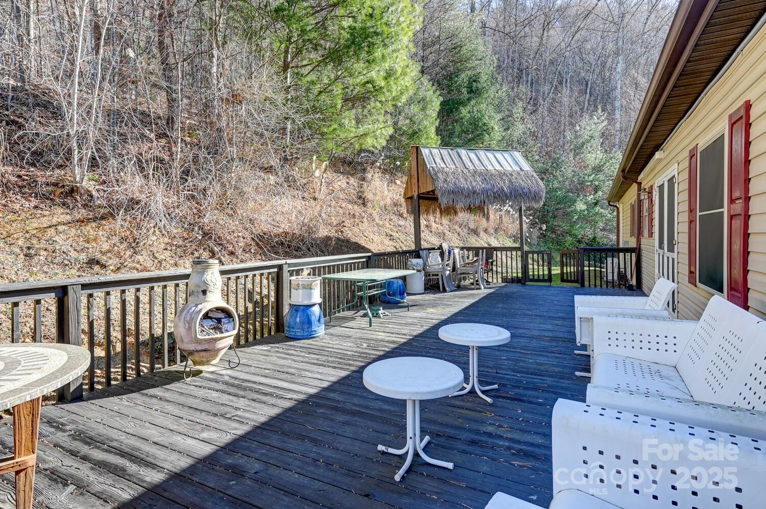 2 Ruffed Grouse Drive Weaverville, NC 28787 - Photo 35 of 44 a view of a roof deck with table and chairs with wooden floor and fence