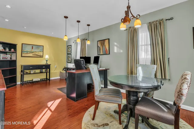 a view of a workspace with furniture and a flat screen tv