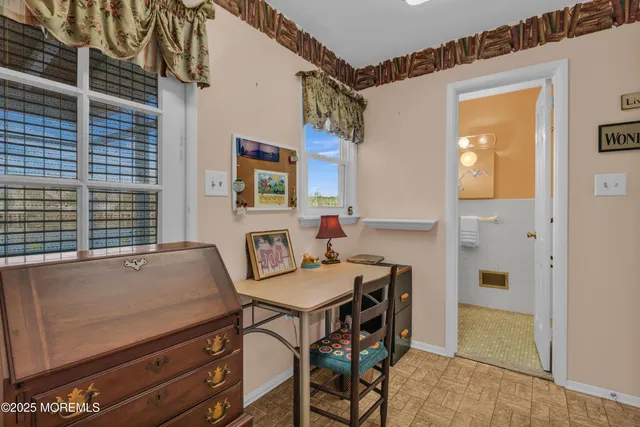 a bathroom with a sink mirror and toilet