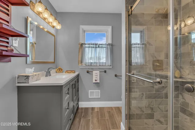 a bathroom with a sink a mirror and a window