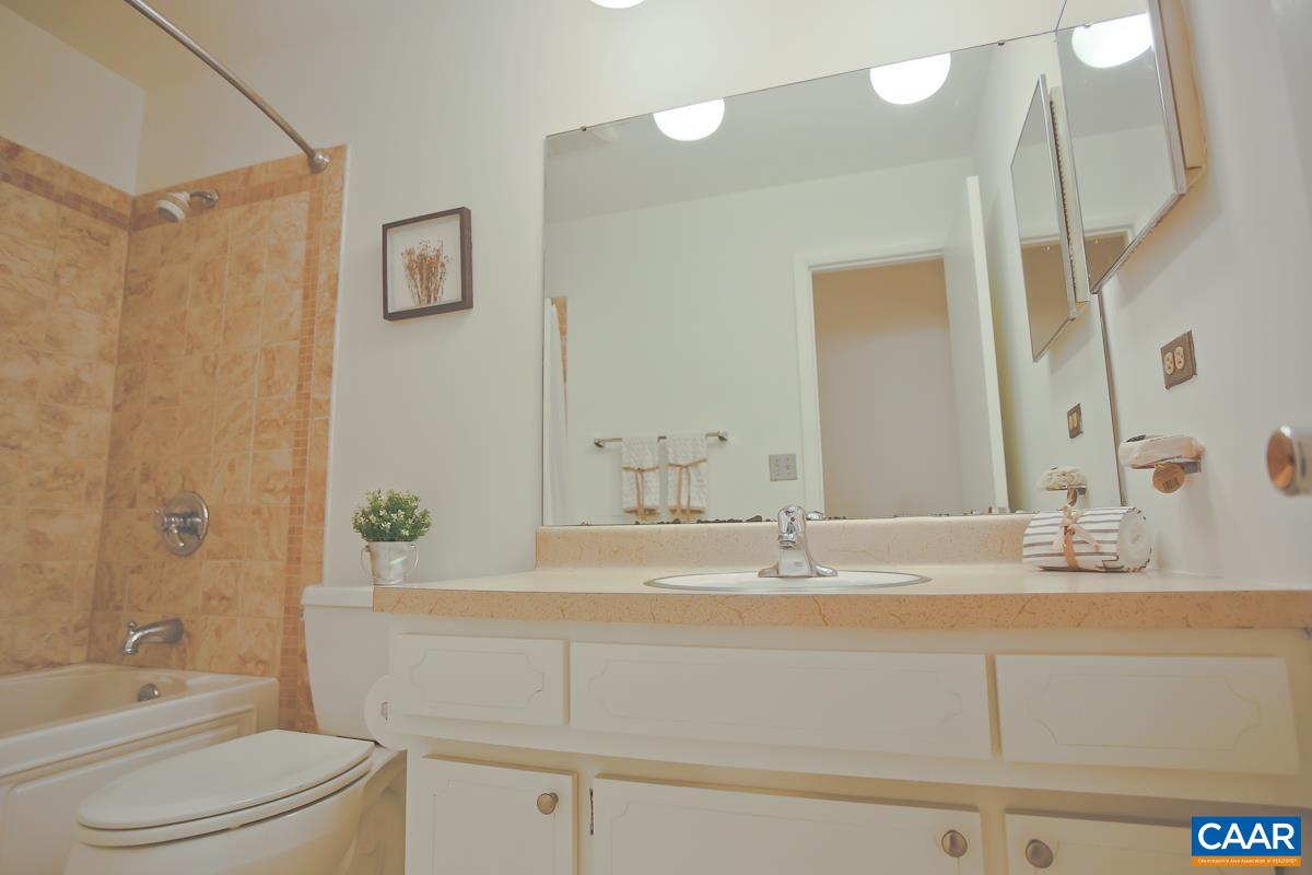 1514 Trailridge Road Charlottesville, VA 22903 - Photo 16 of 23 a bathroom with a granite countertop sink toilet a large mirror a vanity and shower