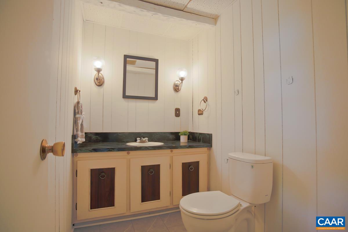1514 Trailridge Road Charlottesville, VA 22903 - Photo 19 of 23 a bathroom with a granite countertop toilet and a sink