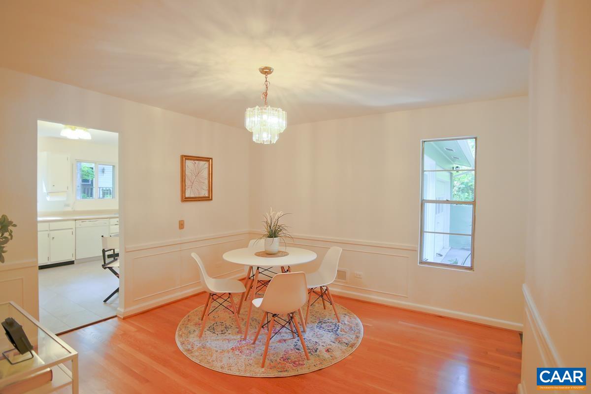 1514 Trailridge Road Charlottesville, VA 22903 - Photo 5 of 23 a dining room with wooden floor a glass table and chairs