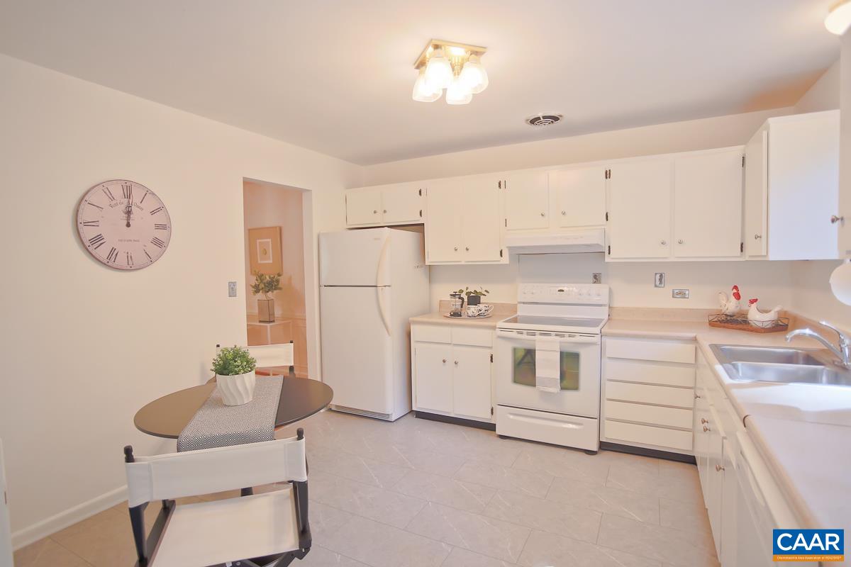 1514 Trailridge Road Charlottesville, VA 22903 - Photo 10 of 23 a kitchen with white cabinets a stove a sink and a refrigerator