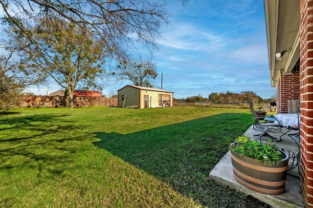 a view of a balcony with table and chairs
