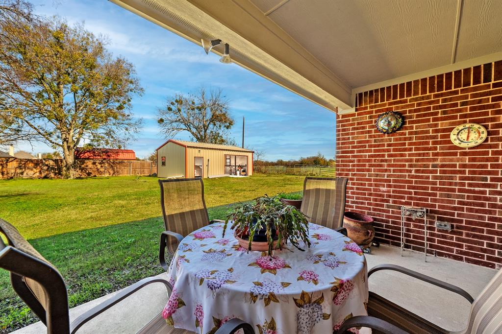 1209 Sherman Street Tioga, TX 76271 - Photo 13 of 40 a view of a balcony with table and chairs