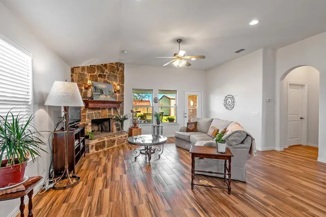 a kitchen with stainless steel appliances granite countertop a sink dishwasher stove refrigerator and cabinets